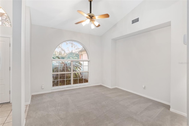 carpeted empty room featuring ceiling fan and high vaulted ceiling