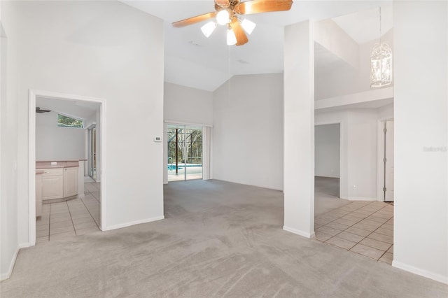 unfurnished room with ceiling fan, light carpet, and high vaulted ceiling