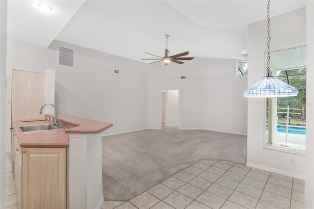 unfurnished living room featuring ceiling fan, sink, light carpet, and vaulted ceiling