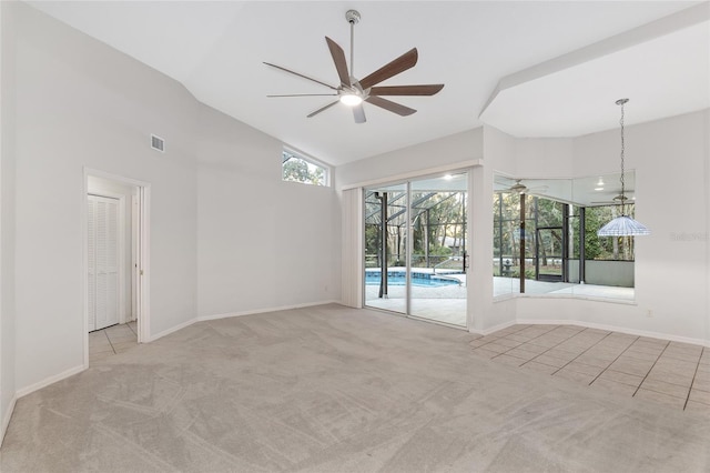 spare room featuring light colored carpet, ceiling fan, and lofted ceiling