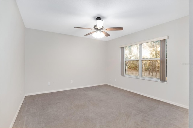 spare room featuring ceiling fan and carpet