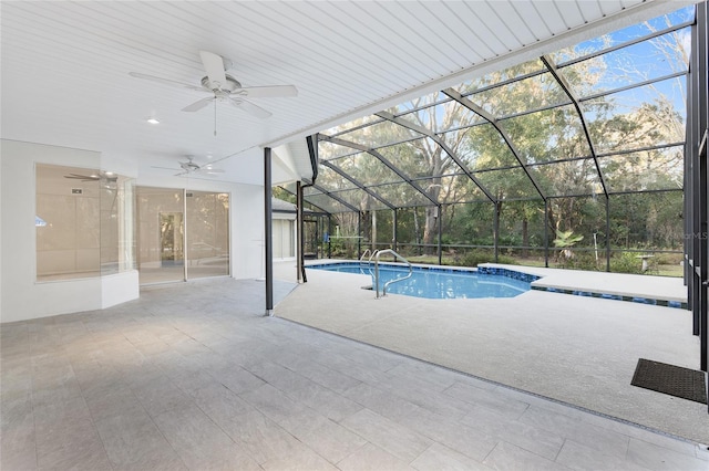 view of pool with glass enclosure, ceiling fan, and a patio area