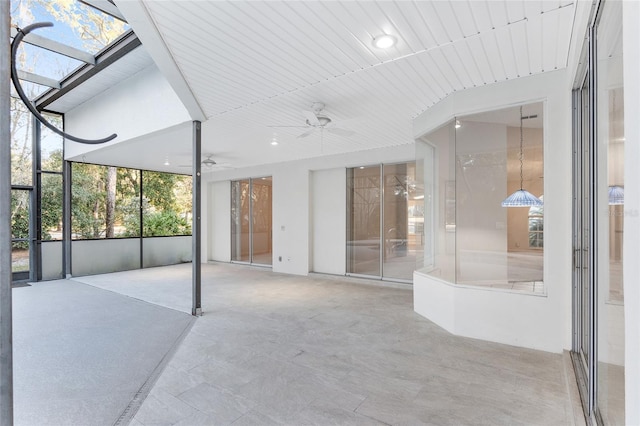 view of patio / terrace featuring glass enclosure and ceiling fan