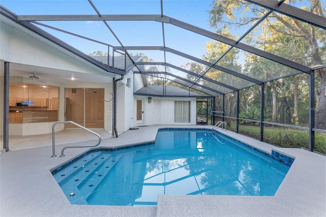 view of swimming pool featuring a patio, ceiling fan, and a lanai