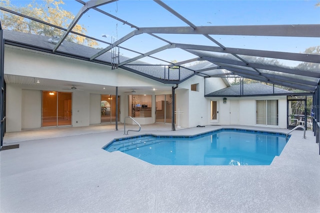 view of pool with ceiling fan, a patio area, and a lanai