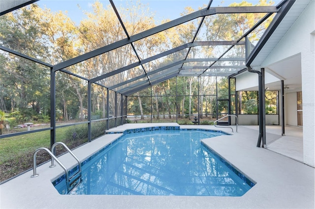 view of pool with a patio and glass enclosure