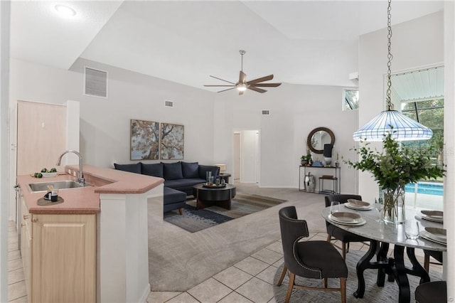 2843 W Elm Blossom St, Beverly Hills, FL 34465 - living area featuring light carpet, light tile patterned floors, a ceiling fan, and a towering ceiling