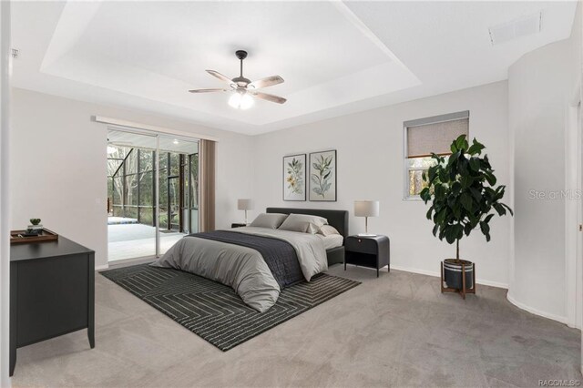 2843 W Elm Blossom St, Beverly Hills, FL 34465 - bedroom featuring access to exterior, carpet, a tray ceiling, and ceiling fan