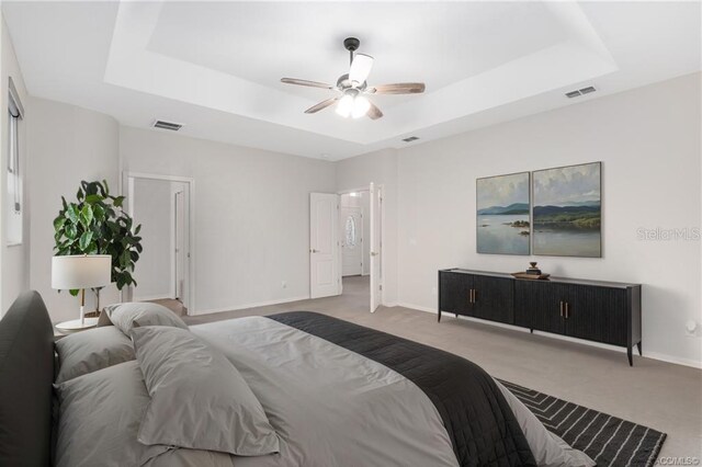 2843 W Elm Blossom St, Beverly Hills, FL 34465 - carpeted bedroom featuring a tray ceiling and ceiling fan