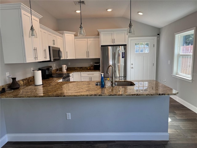 kitchen featuring pendant lighting, dark hardwood / wood-style floors, white cabinets, and stainless steel appliances