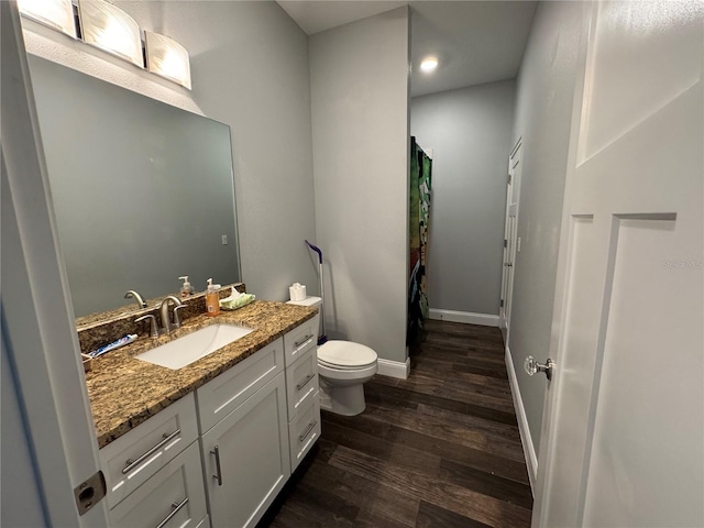 bathroom featuring toilet, vanity, a shower with shower curtain, and hardwood / wood-style flooring