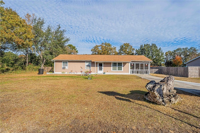 single story home with a sunroom and a front lawn