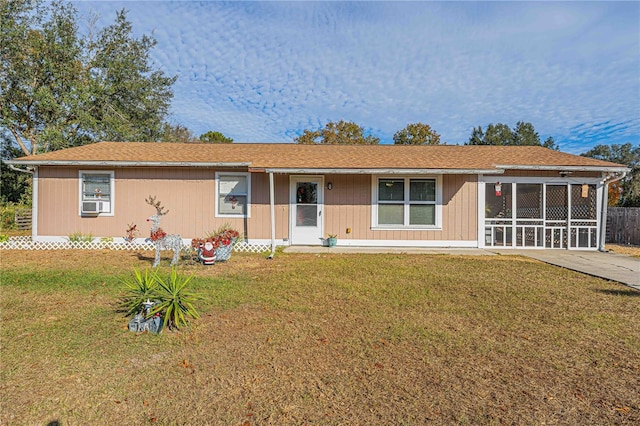 ranch-style house with cooling unit and a front lawn