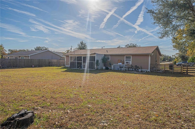 rear view of property featuring a yard