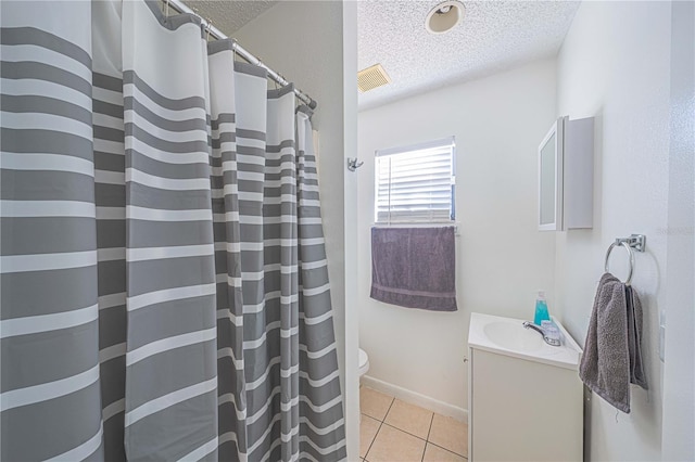 bathroom with curtained shower, tile patterned flooring, a textured ceiling, toilet, and vanity