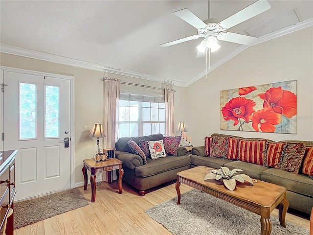 living room with light wood-type flooring, crown molding, a wealth of natural light, and vaulted ceiling