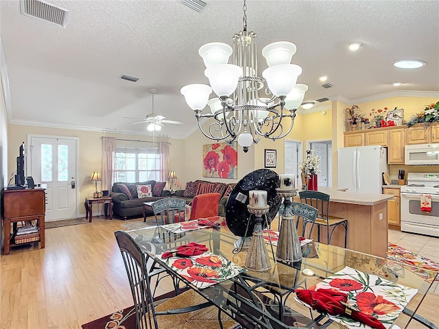 dining area featuring light wood-type flooring, ornamental molding, ceiling fan with notable chandelier, a textured ceiling, and vaulted ceiling