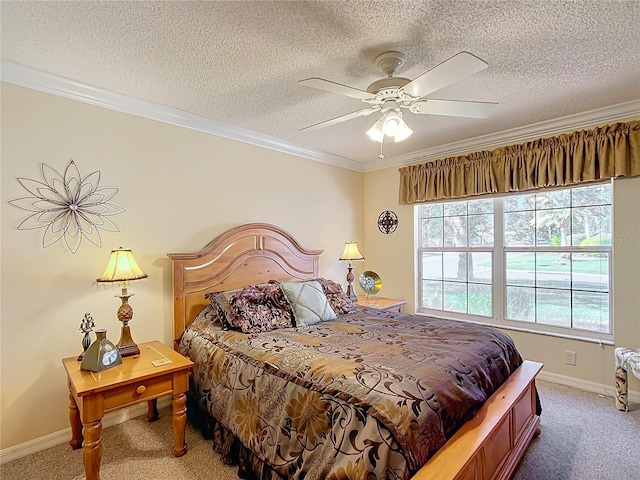 bedroom with carpet, a textured ceiling, ceiling fan, and ornamental molding