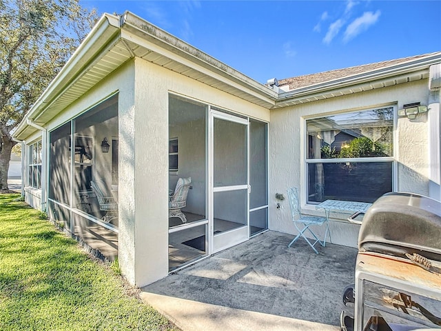 view of property exterior with a sunroom and a patio