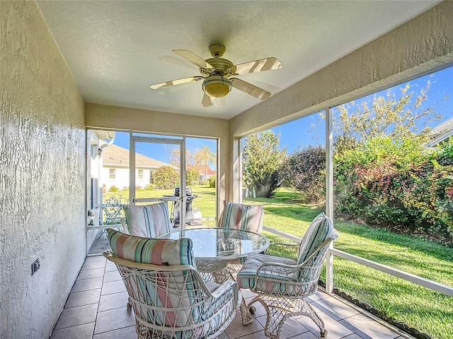 sunroom featuring ceiling fan