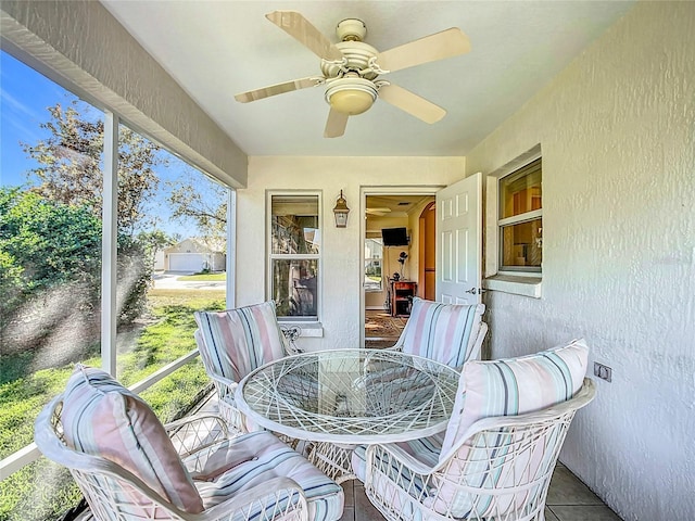 sunroom / solarium with plenty of natural light and ceiling fan