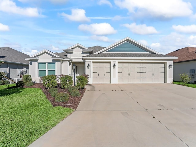 ranch-style home featuring a garage and a front yard