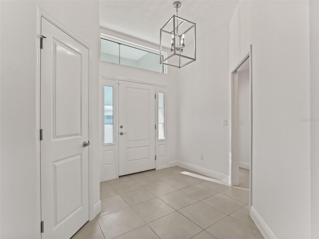 entrance foyer featuring light tile patterned floors and a chandelier