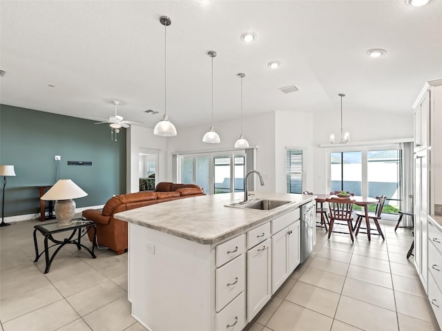 kitchen featuring white cabinets, an island with sink, and a wealth of natural light