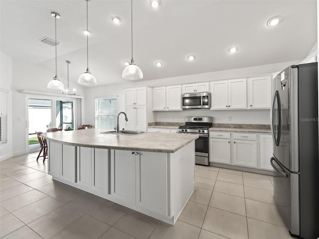 kitchen with sink, decorative light fixtures, a center island with sink, white cabinets, and appliances with stainless steel finishes