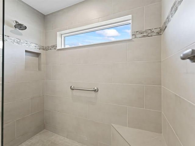 bathroom featuring a tile shower