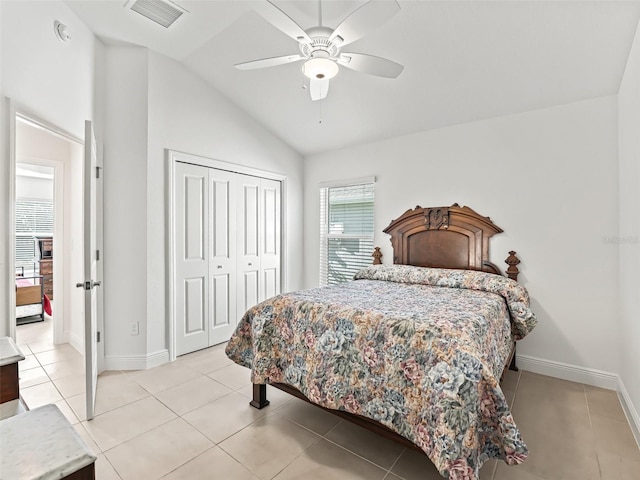 bedroom featuring ceiling fan, vaulted ceiling, light tile patterned flooring, and a closet