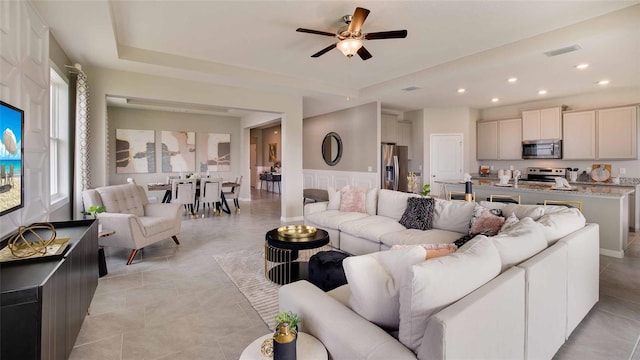 living room featuring ceiling fan and light tile patterned floors