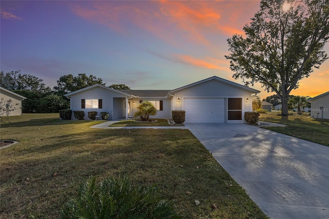 ranch-style house with a lawn and a garage