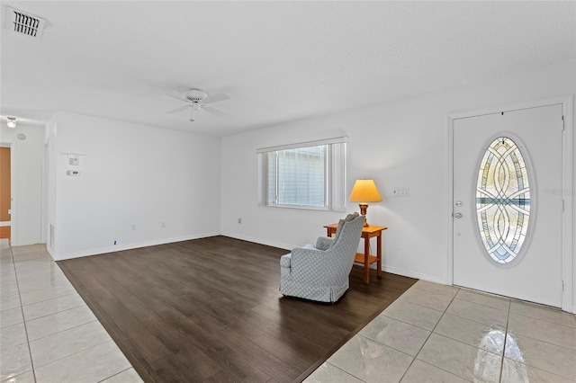 entrance foyer with ceiling fan, a healthy amount of sunlight, and light hardwood / wood-style floors