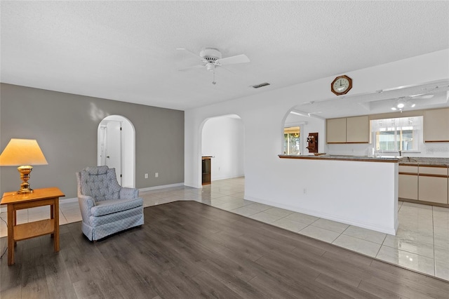 sitting room with a textured ceiling and light hardwood / wood-style flooring