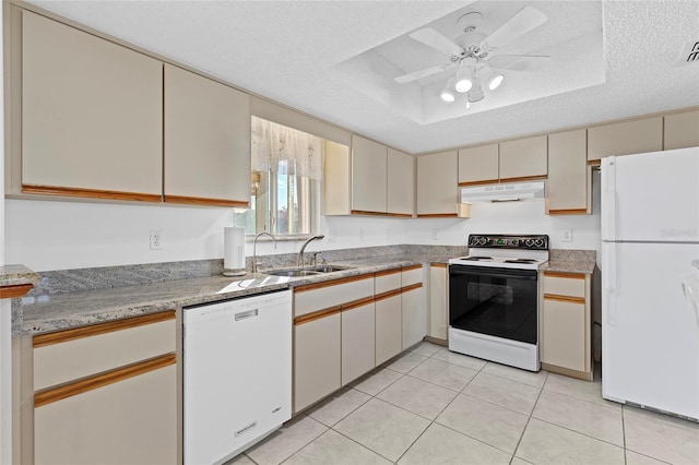 kitchen with ceiling fan, sink, a textured ceiling, white appliances, and a tray ceiling