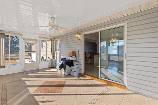 sunroom / solarium featuring ceiling fan