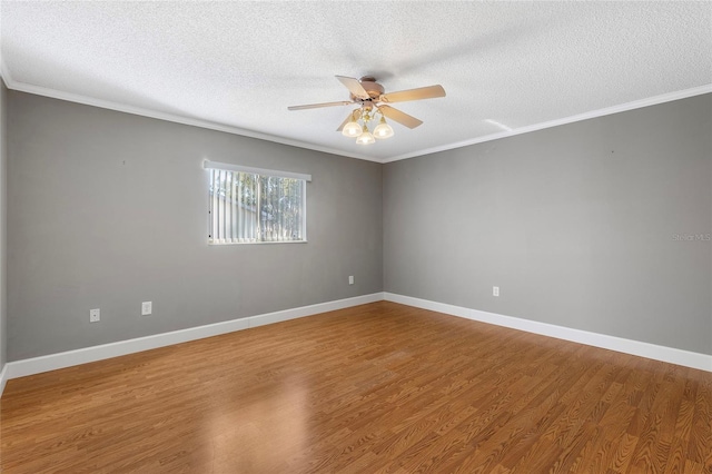 spare room with crown molding, a textured ceiling, and hardwood / wood-style flooring