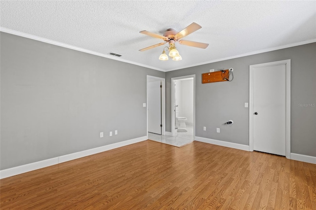 unfurnished room with a textured ceiling, light wood-type flooring, ceiling fan, and crown molding