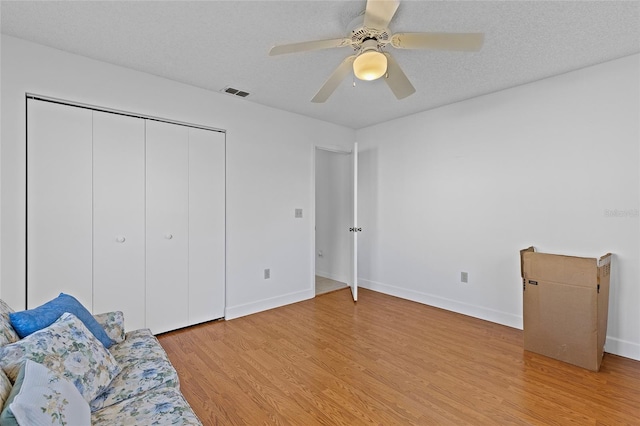 unfurnished room featuring hardwood / wood-style floors, a textured ceiling, and ceiling fan