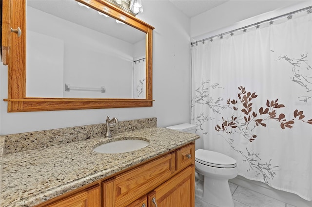 bathroom with tile patterned floors, vanity, and toilet