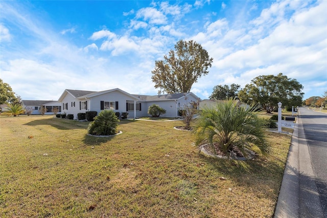 ranch-style home with a front lawn