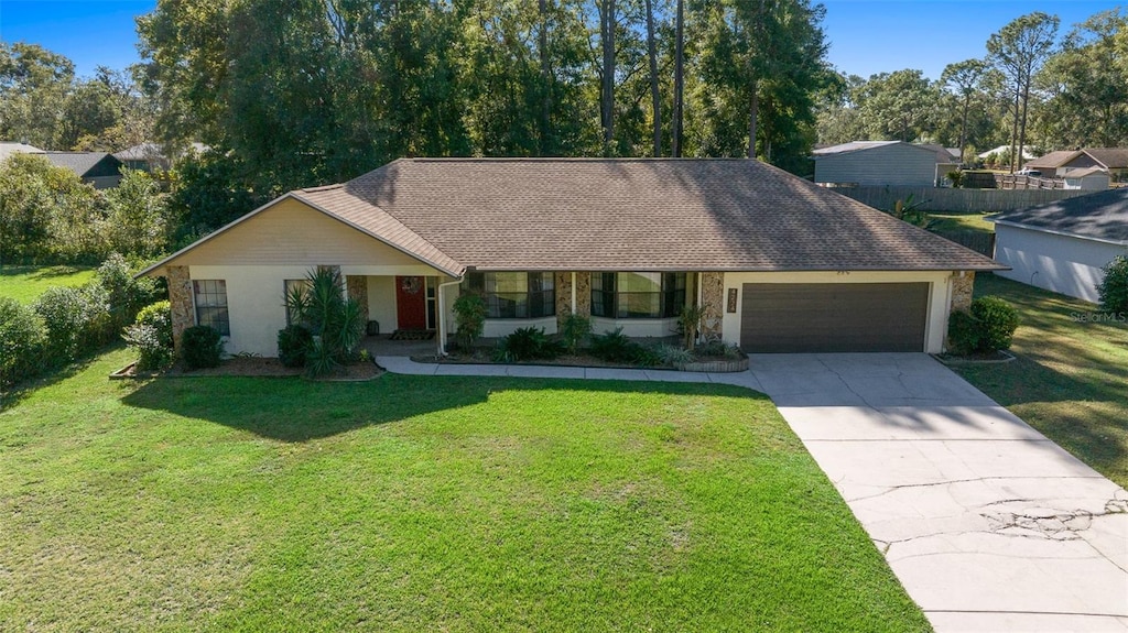 ranch-style home with a front yard and a garage