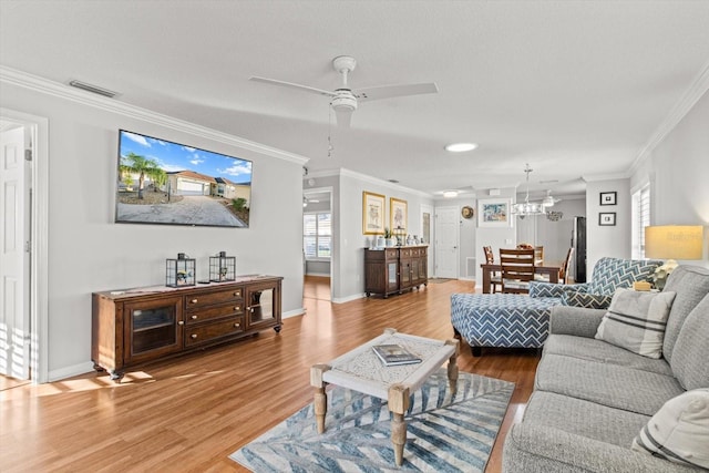 living room with hardwood / wood-style flooring, ceiling fan, and ornamental molding