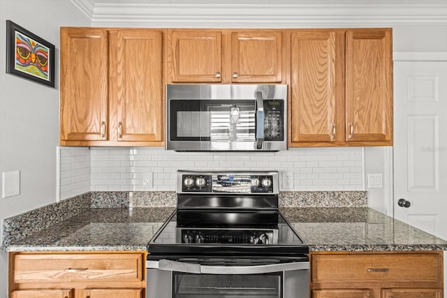 kitchen featuring backsplash, crown molding, stainless steel appliances, and dark stone counters