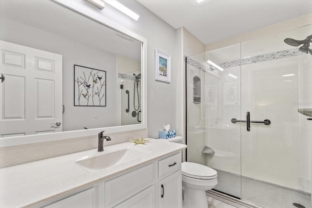 bathroom with vanity, toilet, and an enclosed shower