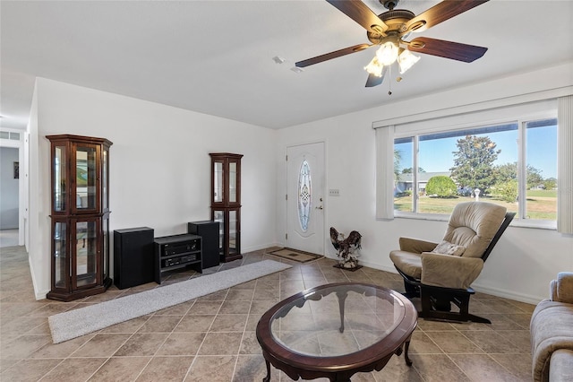 living room featuring ceiling fan and light tile patterned floors