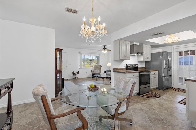 tiled dining room featuring ceiling fan with notable chandelier