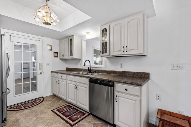 kitchen featuring white cabinets, sink, light tile patterned floors, and stainless steel appliances