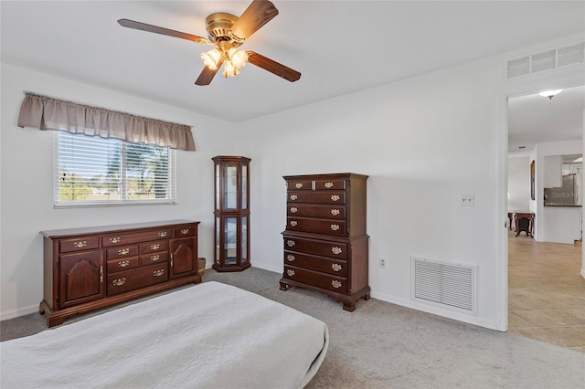 bedroom featuring ceiling fan and light carpet